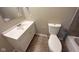 A bathroom with a vanity, mirror, and toilet at 529 S Kiel Ave, Indianapolis, IN 46241