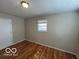 A bedroom featuring hardwood floors and a window at 529 S Kiel Ave, Indianapolis, IN 46241