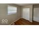 A bedroom featuring hardwood floors, window, and closet space at 529 S Kiel Ave, Indianapolis, IN 46241