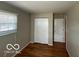 A bedroom featuring hardwood floors, window, and closet space at 529 S Kiel Ave, Indianapolis, IN 46241