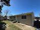 View of the back of the house with a door, windows, and an air conditioning unit at 529 S Kiel Ave, Indianapolis, IN 46241