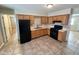 A kitchen featuring wooden cabinets and black appliances at 529 S Kiel Ave, Indianapolis, IN 46241