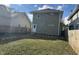 Large backyard with a green lawn and wooden fence at 555 N Oakland Ave, Indianapolis, IN 46201