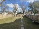 Large backyard with a green lawn and wooden fence at 555 N Oakland Ave, Indianapolis, IN 46201