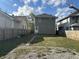 Large backyard with a green lawn and wooden fence at 555 N Oakland Ave, Indianapolis, IN 46201