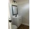 Updated bathroom with white vanity and gray framed mirror at 555 N Oakland Ave, Indianapolis, IN 46201