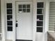Charming white front door with six-light transom window at 555 N Oakland Ave, Indianapolis, IN 46201