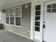 Inviting front porch with updated siding and white door at 555 N Oakland Ave, Indianapolis, IN 46201