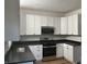 Modern kitchen with white shaker cabinets and dark countertops at 555 N Oakland Ave, Indianapolis, IN 46201