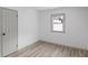 Empty bedroom with light walls, wood-look flooring, and a window at 555 N Sadlier Dr, Indianapolis, IN 46219