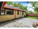 A view of a backyard featuring a stone patio with string lights and a wood fence at 6072 Meridian St W Dr, Indianapolis, IN 46208