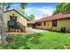 A view of a backyard with a set of stairs, partial stone patio, and lush grass at 6072 Meridian St W Dr, Indianapolis, IN 46208