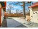 Outdoor patio area featuring modern string lights and a backyard with a wooden fence for enhanced privacy at 6072 Meridian St W Dr, Indianapolis, IN 46208