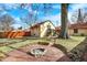 This backyard has mature trees and a custom built stone fire pit for outdoor gatherings at 6072 Meridian St W Dr, Indianapolis, IN 46208