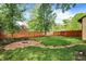 Spacious backyard featuring a fire pit area, wood fence, and green lawn at 6072 Meridian St W Dr, Indianapolis, IN 46208