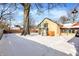 Snowy backyard with large tree and fence at 6072 Meridian St W Dr, Indianapolis, IN 46208