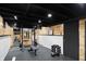 Basement gym with squat rack, weights, and flooring at 6072 Meridian St W Dr, Indianapolis, IN 46208