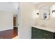 Elegant bathroom with green vanity and marble tile at 6072 Meridian St W Dr, Indianapolis, IN 46208