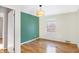 Bedroom with hardwood floors and green accent wall at 6072 Meridian St W Dr, Indianapolis, IN 46208