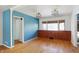 Dining room with hardwood floors, built-in cabinets, and blue accent wall at 6072 Meridian St W Dr, Indianapolis, IN 46208