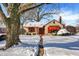 Snow-covered charming house with red awnings and stone pathway at 6072 Meridian St W Dr, Indianapolis, IN 46208