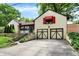 A beautiful home featuring a 2 car garage, red awnings, and lush landscaping at 6072 Meridian St W Dr, Indianapolis, IN 46208