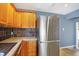 Modern kitchen with stainless steel appliances and wood cabinets at 6072 Meridian St W Dr, Indianapolis, IN 46208