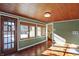 Charming sunroom featuring wood floors and French doors at 6072 Meridian St W Dr, Indianapolis, IN 46208