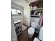 Compact bathroom with storage shelves and a window for natural light at 630 E Mccarty St, Indianapolis, IN 46203