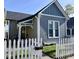 Gray home with a white picket fence, offering curb appeal and a cozy neighborhood feel at 630 E Mccarty St, Indianapolis, IN 46203