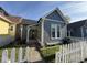 Charming gray home with a white picket fence and well-maintained front yard landscaping at 630 E Mccarty St, Indianapolis, IN 46203