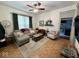 Bright living room featuring hardwood floors, a ceiling fan, and cozy seating arrangement at 630 E Mccarty St, Indianapolis, IN 46203