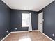 Simple bedroom with tiled floor, window, and white door at 6338 Cooper Pointe Dr, Indianapolis, IN 46268