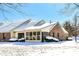 Brick home with snow covered roof and yard at 6425 Peace Pl, Indianapolis, IN 46268