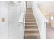 Beige carpeted staircase with white railings at 6670 W Irving Dr, McCordsville, IN 46055