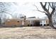 Charming brick ranch home featuring a front yard, chimney, and a welcoming white front door at 7201 E 71St St, Indianapolis, IN 46256