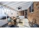 Bright screened porch features wicker furniture and a ceiling fan at 7201 E 71St St, Indianapolis, IN 46256