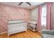 Charming Bedroom with pink accent wall and crib at 9400 N Bishop Ln, Mooresville, IN 46158