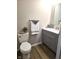Bathroom featuring a modern vanity, a toilet, and decorative accents at 9812 W 900 N Rd, Elwood, IN 46036
