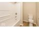 Simple bathroom with white tub, shower, and toilet at 9812 W 900 N Rd, Elwood, IN 46036