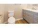 Bathroom with gray vanity, white toilet, and vinyl flooring at 9812 W 900 N Rd, Elwood, IN 46036