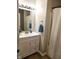 Neat bathroom with a modern vanity, clean white shower curtain, and neutral decor at 9812 W 900 N Rd, Elwood, IN 46036
