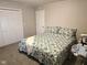 Comfortable bedroom with neutral walls, plush carpet, and a floral patterned bedspread at 9812 W 900 N Rd, Elwood, IN 46036
