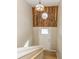 Inviting entryway with wood accent wall, light fixture, and staircase at 9812 W 900 N Rd, Elwood, IN 46036