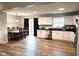 Bright and spacious kitchen and dining area with white cabinetry and wood flooring at 9812 W 900 N Rd, Elwood, IN 46036