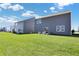 Spacious backyard with lush green grass, patio, and modern siding offers ideal outdoor living at 11614 Hartwell St, Indianapolis, IN 46235