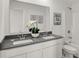 Bright bathroom with double sinks, a large mirror, and a shower/tub combo at 11614 Hartwell St, Indianapolis, IN 46235