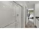 Modern bathroom featuring a glass enclosed shower, chrome fixtures, and access to the main bedroom at 11614 Hartwell St, Indianapolis, IN 46235
