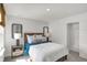 Comfortable bedroom features a queen-sized bed, two windows, decor, and bedside tables at 11614 Hartwell St, Indianapolis, IN 46235