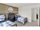 Cozy bedroom with two twin beds, wood wall decor, and a window at 11614 Hartwell St, Indianapolis, IN 46235